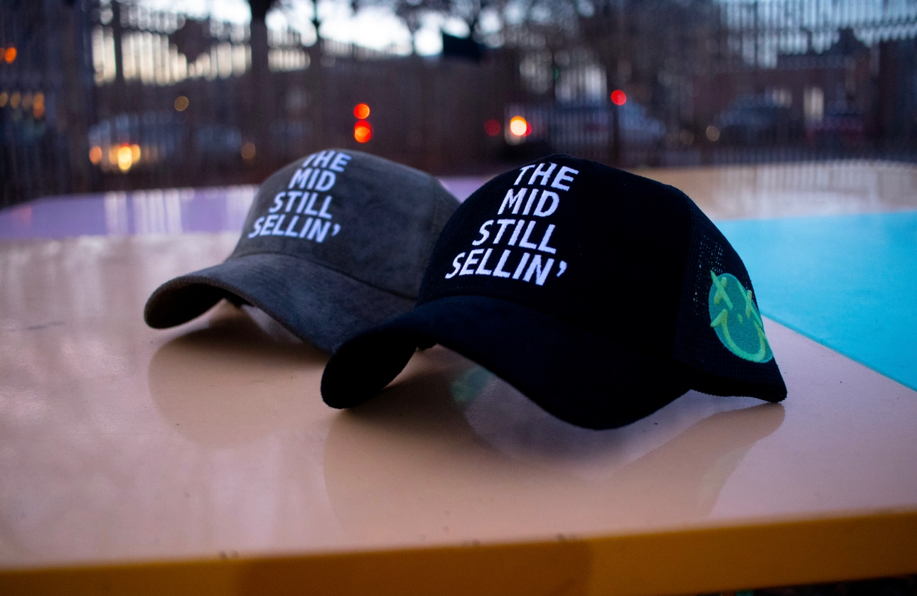 The Mid Still Sellin' Trucker Hat